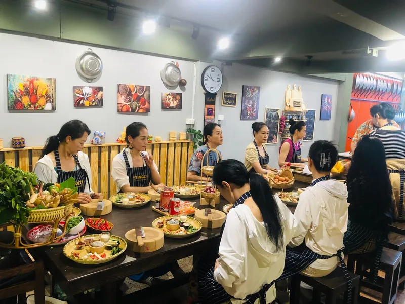 Students plating finished Thai dishes at Tingly Thai cooking school during a Bangkok Thailand tours half-day cooking class